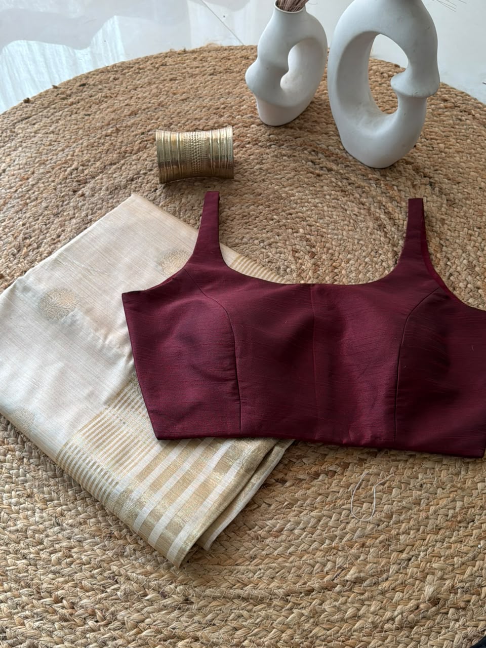 Sunheri Onam saree with maroon scoop neck stitched blouse.
