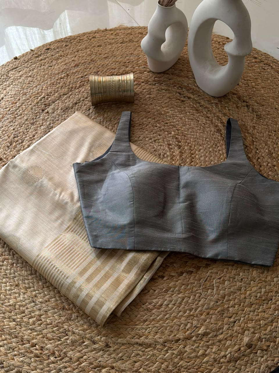 Sunheri Onam saree with Grey scoop neck stitched blouse.
