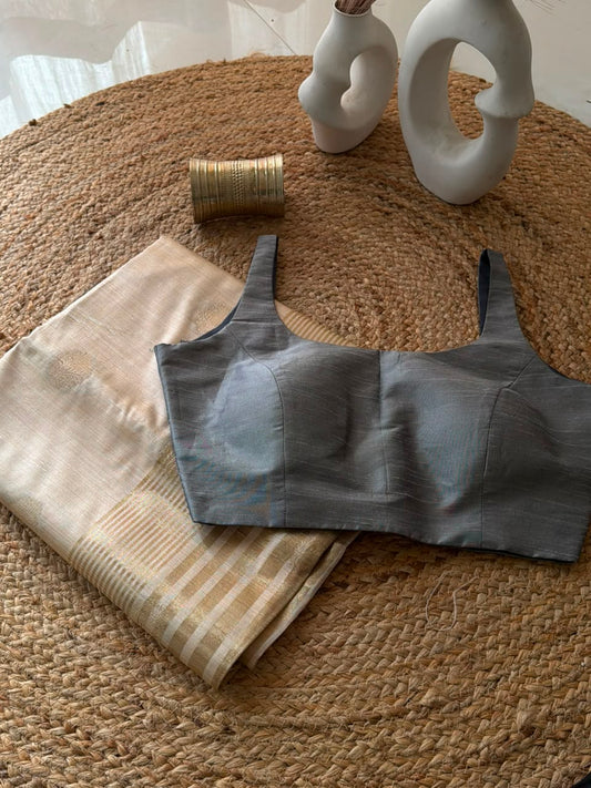 Sunheri Onam saree with Grey scoop neck stitched blouse.
